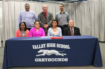 Family members and coaches join Valley High School's Alexis Payne for a photo after she signed to play at Rio Grande